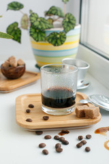 Vietnamese alternative method brewing, Devices for coffee in the background, coffee with sweetened condensed milk in glass, hipster morning routine concept