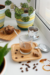 Alternating filter manual brewing of coffee close up. Devices for coffee in the background, coffee with sweetened condensed milk in glass, hipster morning routine concept
