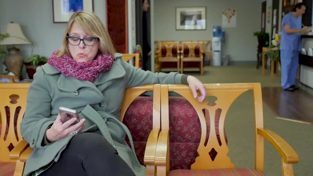 Frustrated woman watching a man walk in and get seen by a doctor immediately