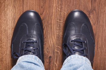 Navy blue shoes for men on rustic board, male footwear concept