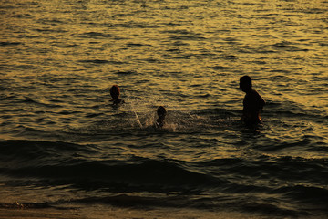 Silhouette of adorable little girl on a beach at sunset
