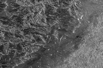 River ice texture background close up. Black and white