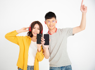 Happy couple enjoy music from smart phone