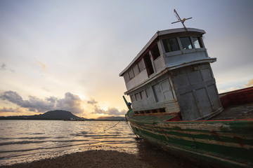 Old fishing boat at sunset
