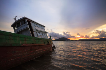 Old fishing boat at sunset