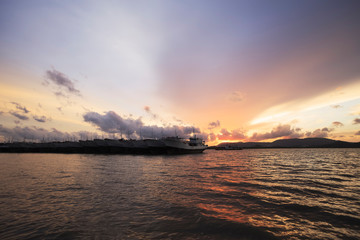 Naklejka premium Old fishing boat at sunset