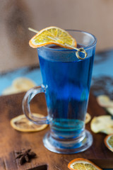 Glass of cocktail on table on a blue background