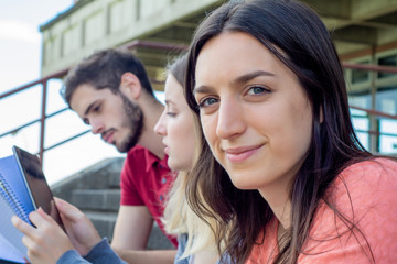 Group of  University students studying together outdoors