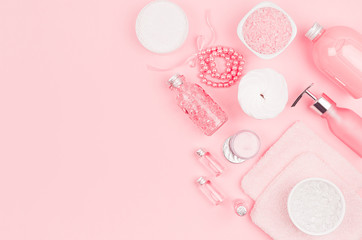 Obraz na płótnie Canvas Different cosmetic products and accessories in pink and silver color on soft light pink background, copy space, top view.