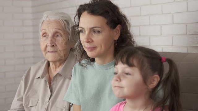 Doing family portrait. Three generations of women in the same family.
