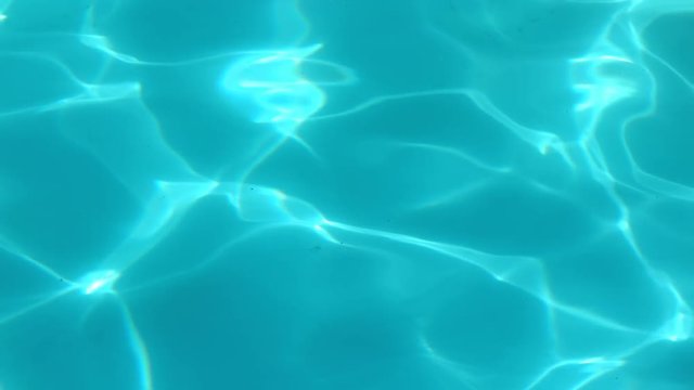 Water surface of a shiny blue swimming pool 4k
