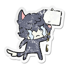 distressed sticker of a crying fox cartoon with placard