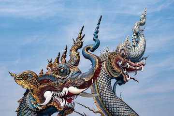 Fototapeta premium A pair Naga in front of blue buddhist church in Thai temple 