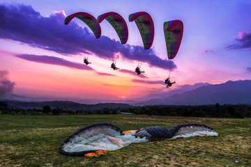 Paragliding is an aerial sport where you can let your body be free and feel that chill of the wind flying several thousands of meters high in the sky. Action shot of a para-glider landing - 253230630
