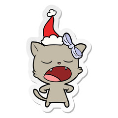 sticker cartoon of a yawning cat wearing santa hat