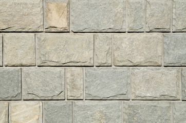 Sliced gneiss cladding slabs on wall close up