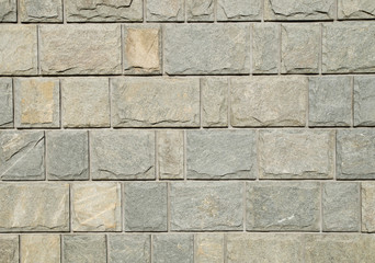Sliced gneiss cladding slabs on wall close up
