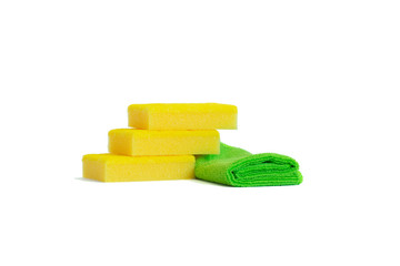 Yellow dish sponges and a green microfiber towel. Isolated on white background. Copy space.