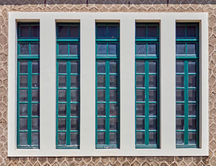 classic modern linear window with blue green painted wooden frames