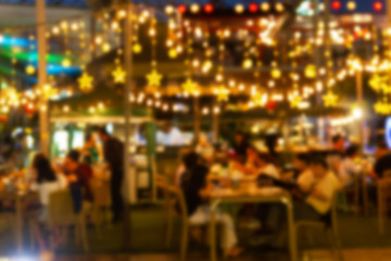 abstract blur image Lots of people enjoy the fun of night festival in a restaurant and The atmosphere is happy and relaxing.