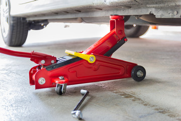 red tool jack lift car for repair check Maintenance of cars
