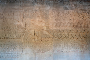 Relief of churning of Sea of milk on the wall of gallery of Angkor Wat temple. Chief of the demons