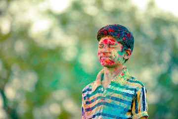 Indian child playing with the color in holi festival