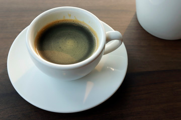 Hot coffee on wood background, black coffee.
