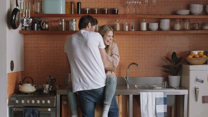 cheerful young couple hugging in kitchen having fun romantic relationship embracing sharing intimate connection enjoying happy lifestyle together
