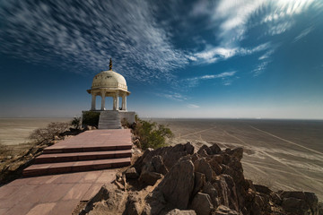 Long exposure of a full moon night with puffy clouds at the hill top vantage point at Sambhar salt...