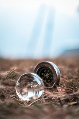 A mini compass and a crystal ball arranged on ground in the tiny Himalayan village of Lagga, located in Chamba - 253237695