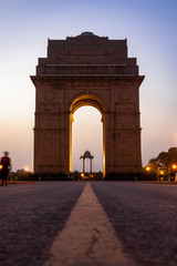Fototapeta na wymiar Freestyle football juggling at India Gate during sunrise with flying birds in New Delhi