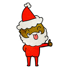man with beard sticking out tongue wearing santa hat