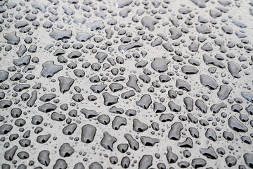 irregular water drops on dark surface, drops of different shape