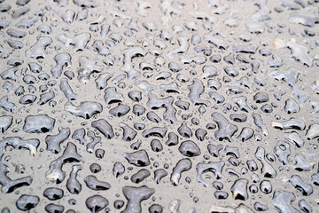 water drops in different shapes, macro photography water droplets of irregular shape on the dark surface