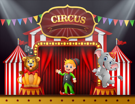 Circus trainer with elephant and lion on the stage