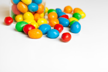 Bottles with sweet candies on table