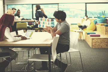 black muslim business woman having a meeting with her indian male colleague