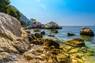 Fototapeta na wymiar Sea beach with stones and rocks, Beausoleil, Nice, Nizza, Alpes-Maritimes, Provence-Alpes-Cote d'Azur, Cote d'Azur, French Riviera, France