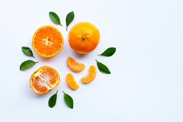 Orange fruits and green leaves on a white background.