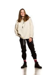 Young happy model in hoodie on white background