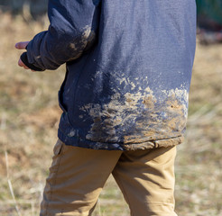 Dirt on the jacket of the boy