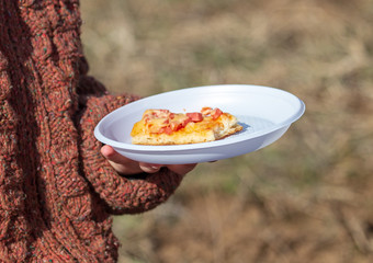 Pizza in a plastic plate in nature