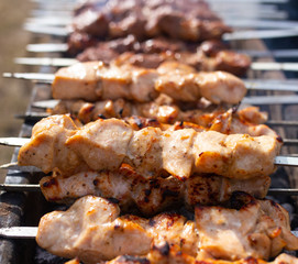 Shish kebab on skewers is fried on a brazier