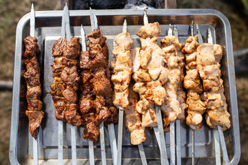 Shish kebab on skewers is fried on a brazier