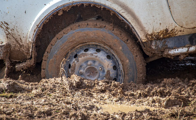 Car wheel slips in the dirt in nature