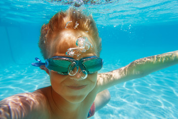 happy little boy make selfie while swim underwater