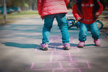 little girls play hopscotch on playground, kids outdoors