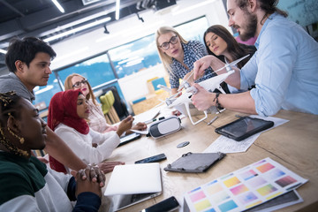 Obraz premium multiethnic business team learning about drone technology