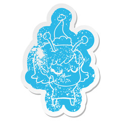 smiling alien girl cartoon distressed sticker of a wearing santa hat